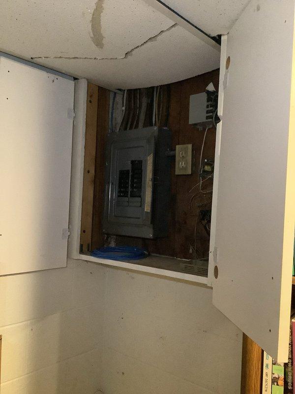 Completed installation of a new mast service with a two-gang meter base and dual 100 amp disconnects on garage exterior, including proper grounding system with new ground rods, waterline ground, and hot water tank bonding. Replaced 100 amp panel in front section of duplex and ran conduit from disconnects to refeed both front and back panels, ensuring complete electrical service upgrade to code requirements.