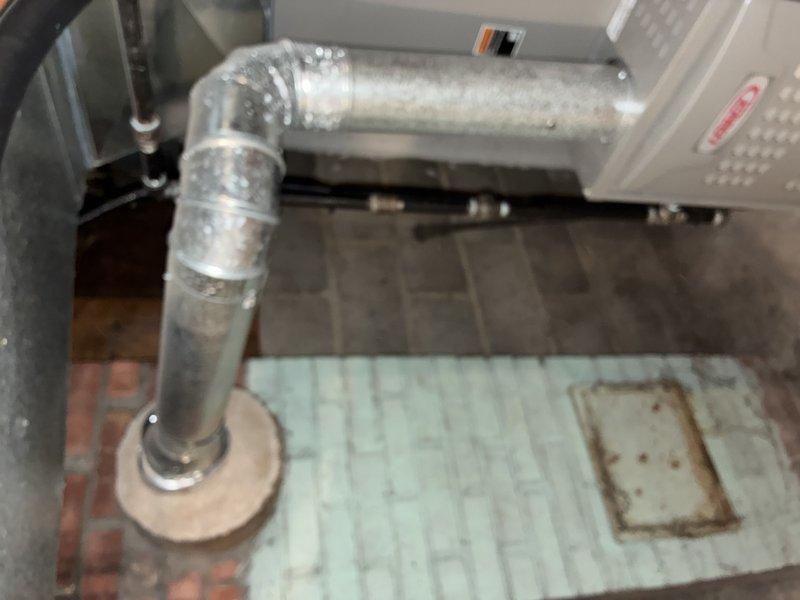 Performed scheduled MVP furnace maintenance including inspection of ductwork connections and sealing of joints. Removed and cleaned the existing pleated air filter, noting condensation present on filter surface, and reinstalled after service.