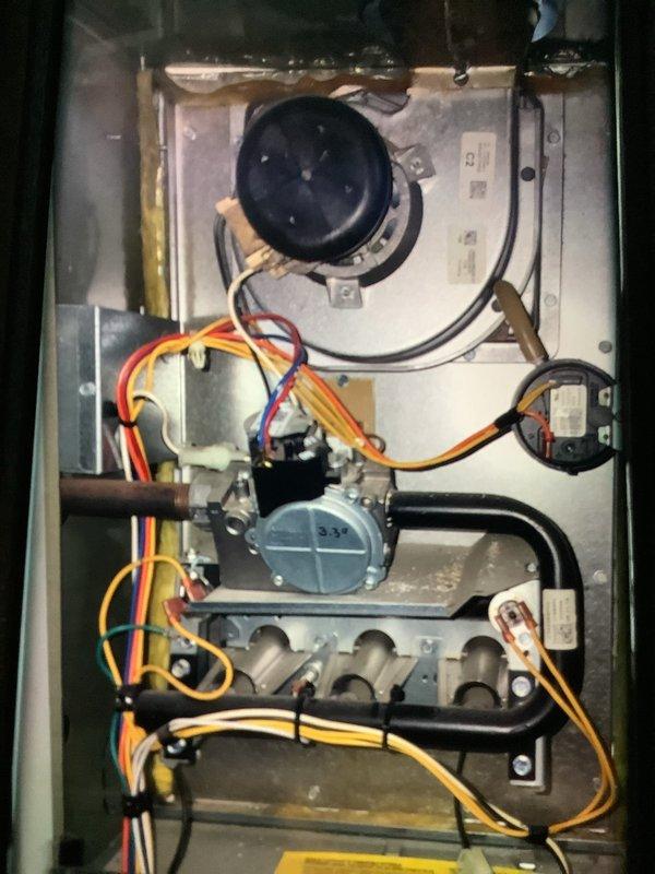Performed maintenance on a gas furnace of undetermined age. Conducted electrical measurements using UEi EM2018 meter, obtaining readings of 3287 on system components. Inspected blower motor, heat exchanger, and wiring connections for proper operation. Evaluated ductwork condition to assess need for cleaning service.