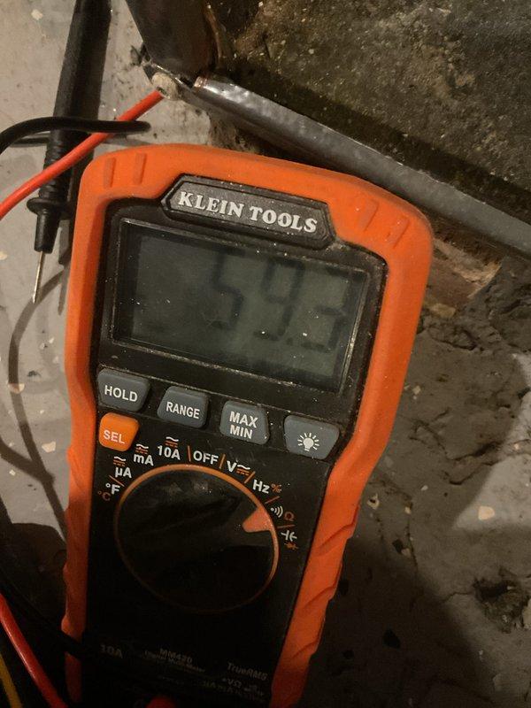 Performed scheduled MVP heating maintenance service. Conducted electrical testing on system components using digital multimeter, measuring resistance values at 53.5 ohms. Inspected copper piping and connections, noting mineral buildup and corrosion on main supply line that requires monitoring but is currently functioning within acceptable parameters.