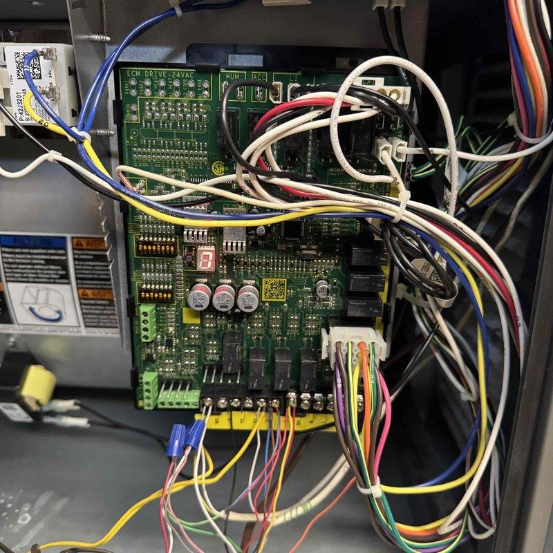 Performed scheduled MVP furnace maintenance visit, inspecting the basement-installed HVAC system including the main furnace unit and associated ductwork. Examined the ECM drive control board which displayed a "3" code, verified all electrical connections were secure, and confirmed proper operation of all components including the PVC venting system.