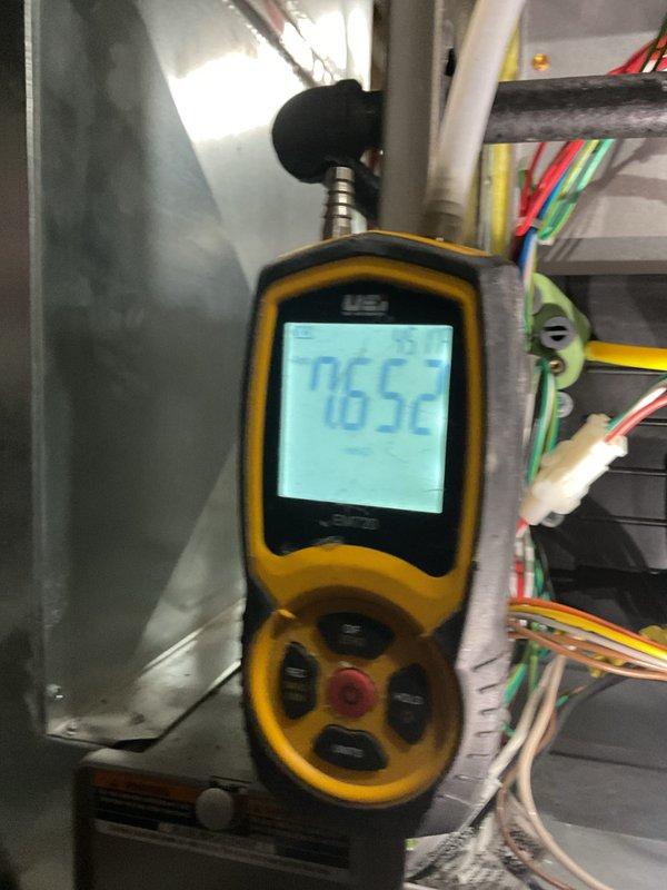 Performed routine maintenance on 4-year-old gas furnace. Conducted electrical testing with multimeter showing 542 reading, and verified combustion efficiency with combustion analyzer reading 76.52%. Inspected ductwork to evaluate need for cleaning service.