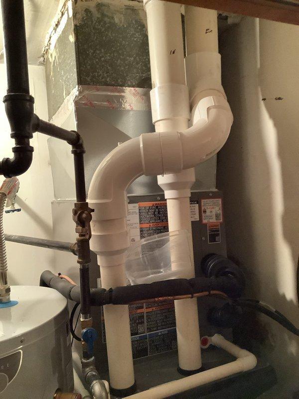 Completed replacement of leaking exhaust pipe system under warranty. Installed new 3" PVC exhaust piping with proper elbow joints and connections, ensuring all safety requirements were met as indicated on manufacturer warning labels. Photo documentation confirms professional installation of the complete exhaust system with all components properly secured and functional.