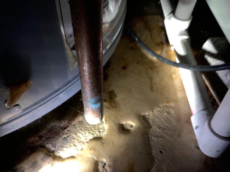 Completed the installation of a new 50-gallon A.O. Smith water heater with 6-year warranty, replacing the previous unit which showed signs of corrosion and water damage at the base. Installation included a new ball valve, thermal expansion tank, and replacement of an old saddle valve with a new 1/4" valve on the cold side for the ice maker connection. Noted cosmetic dent on bottom of tank as discussed during quote process.