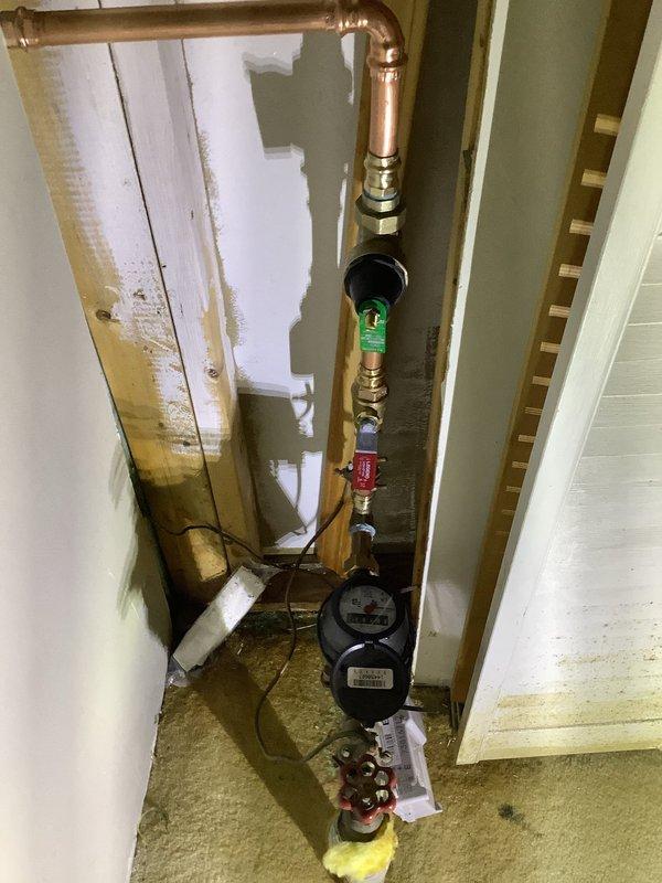 Replaced faulty pressure reducing valve due to excessive water pressure exceeding 100 psi which was causing the temperature and pressure relief valve to leak. Modified plumbing configuration at the meter by installing two isolation ball valves on either side of the new pressure reducing valve, improving accessibility and serviceability of the system.