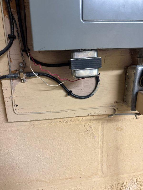 Diagnosed and repaired garage spotlight electrical issue by replacing damaged transformer mounted on the wooden backing panel. Restored functionality to the non-working doorbell system by reconnecting loose wiring and testing the circuit to verify proper operation.