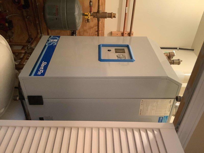 Performed diagnostic service on 60+ year old CHS Slant Fin CHS 110 boiler system experiencing lukewarm water at all taps. Inspected pressure gauge readings, copper piping connections, and evaluated SWT water heater unit with suspected diverter valve malfunction. Confirmed error codes align with previous diagnosis and documented system condition with photos for further assessment.