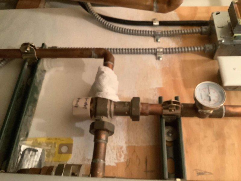 Performed diagnostic service on 60+ year old CHS Slant Fin CHS 110 boiler system experiencing lukewarm water at all taps. Inspected pressure gauge readings, copper piping connections, and evaluated SWT water heater unit with suspected diverter valve malfunction. Confirmed error codes align with previous diagnosis and documented system condition with photos for further assessment.