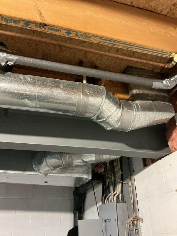Responded to a service call regarding a water leak identified during a home inspection. Upon examination of the basement plumbing system, which includes a water filtration unit with blue cylindrical tank and associated pipe assembly, no active leaks were detected. Inspected all connections, pressure regulator, and control valves throughout the system, confirming proper operation and integrity of all components.