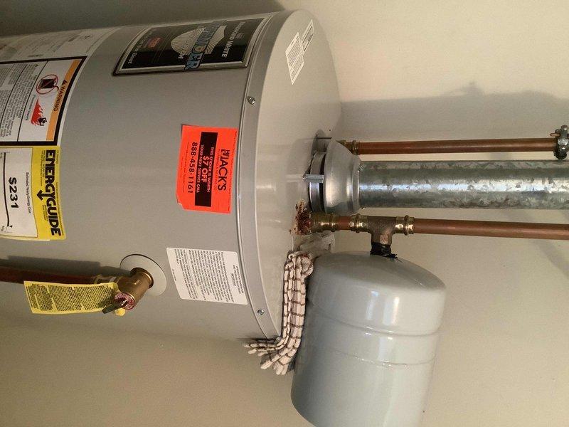 Replaced failed expansion tank with new assembly including tee, tank, and proper bracket to ensure secure installation. Removed and replaced damaged cold water diptube with new diptube and female adapter compatible with RG240S6N water heater. Corrected previous installation issues to ensure proper functionality and prevent future corrosion at pipe connections.