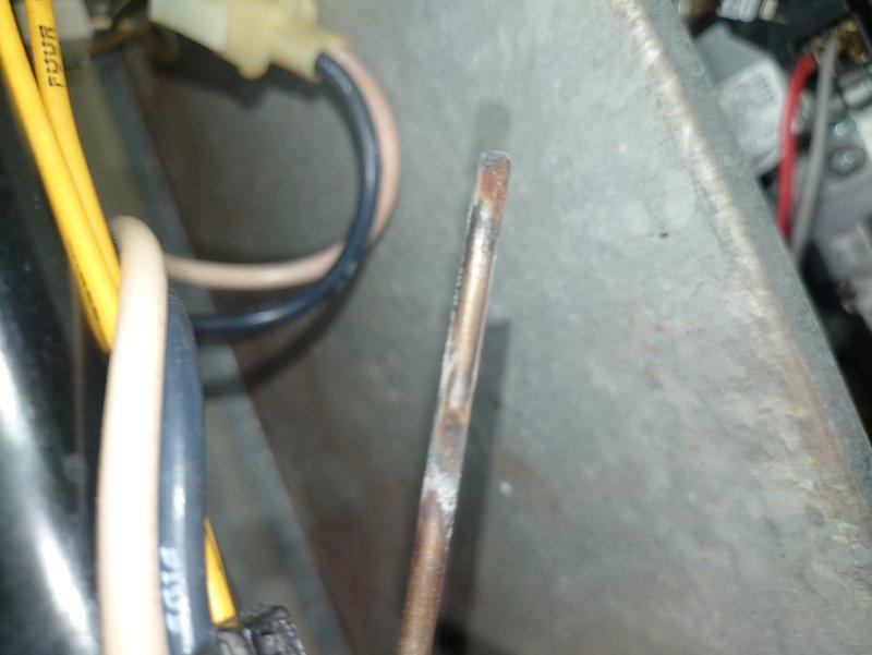 Performed comprehensive tune-up on 30-year-old residential furnace system, which included inspection of ignition assembly showing signs of corrosion and wear. Examined and cleaned flame sensor and burner assembly components, addressing oxidation on copper heat exchanger discs. System was restored to functional operation despite age-related deterioration, though customer was advised that replacement should be considered in near future due to component wear.