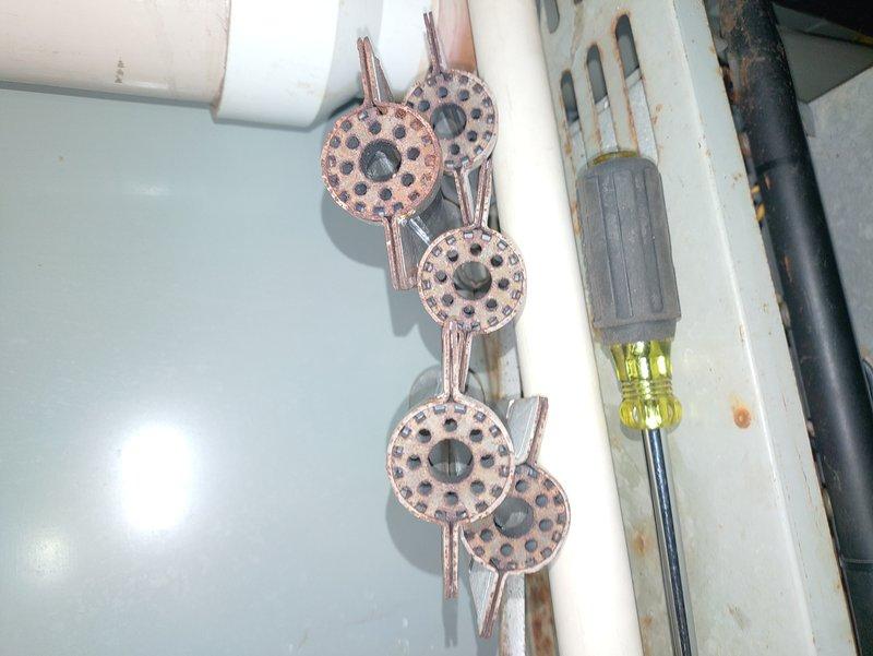 Performed comprehensive tune-up on 30-year-old residential furnace system, which included inspection of ignition assembly showing signs of corrosion and wear. Examined and cleaned flame sensor and burner assembly components, addressing oxidation on copper heat exchanger discs. System was restored to functional operation despite age-related deterioration, though customer was advised that replacement should be considered in near future due to component wear.