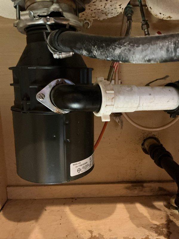 Responded to service call for kitchen sink clog. Inspected garbage disposal unit, which was properly connected to drain system with appropriate PVC drainage pipe and flexible waste line. Cleared obstruction and verified proper drainage function. Basement inspection revealed no issues with main drain lines or plumbing infrastructure.