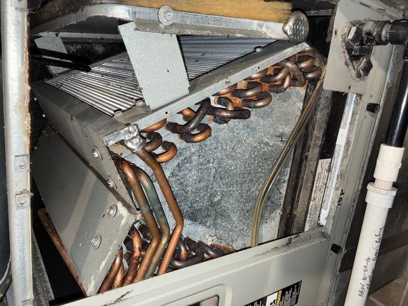 Performed MVP furnace maintenance service, including inspection of heat exchanger which showed significant dust buildup on fins that could impact efficiency. Thoroughly examined copper evaporator coils which appeared intact but required cleaning to remove visible dust accumulation in the housing area beneath. Completed standard preventative maintenance procedures to restore optimal system operation.