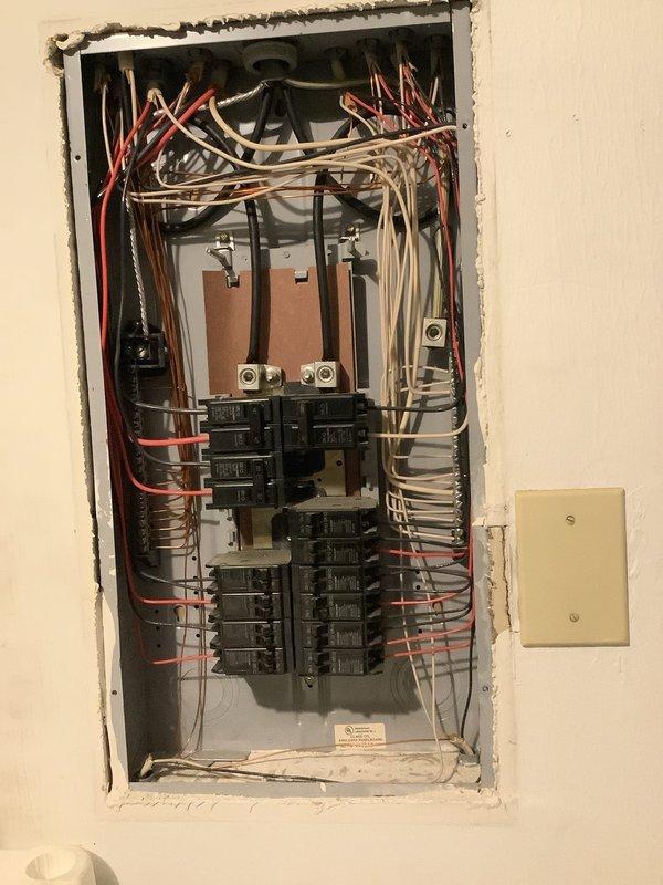 Inspected electrical service panel and meter installation in response to recurring power strip issues that damaged customer's electronic devices. Found disorganized internal wiring in the panel with insufficient wire management, and significant dead vegetation accumulating against the exterior meter box which could potentially cause access issues. Resolved tripping issue by identifying and replacing a faulty receptacle that was causing the power strip to malfunction.