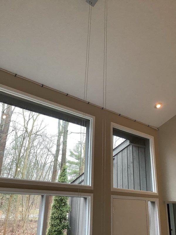 Successfully rerouted water feed line from frozen exterior section to an interior path, running new copper piping above kitchen cabinets, along the kitchen contour, across the living area beam, up to the second floor, and reconnecting to the existing system in the utility room. Abandoned the damaged exterior line in place to prevent further freeze issues. Verified proper operation of the Lochinvar water heater system with all connections secure and leak-free.