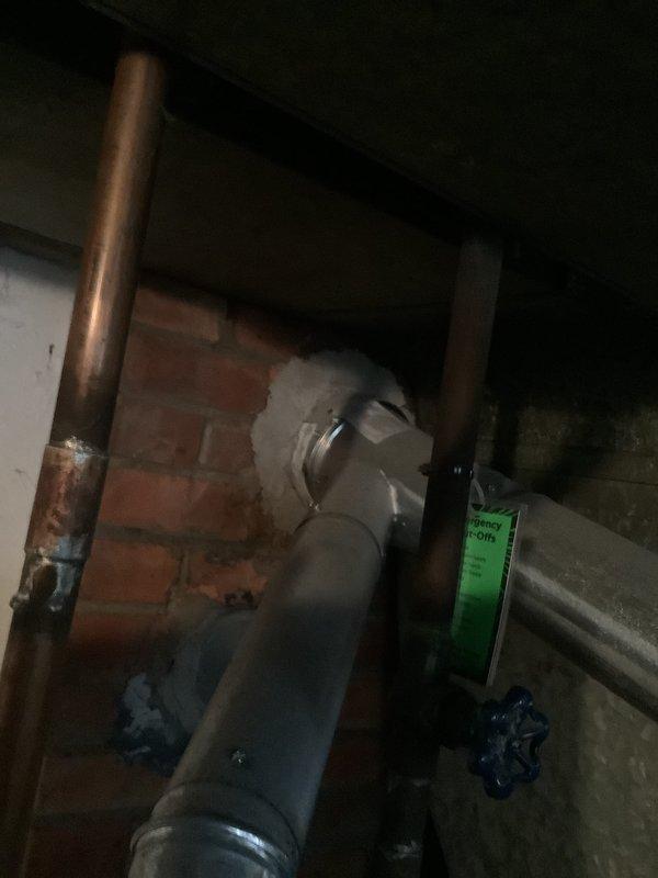 Conducted furnace replacement estimate in basement utility area. Existing unit shows significant age with visible corrosion on connecting copper pipes and plumbing components. Documented current system configuration including ductwork and water connections to provide accurate replacement options.