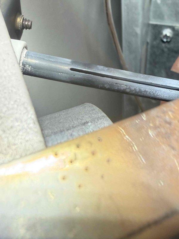 Replaced failing igniter that was showing clear signs of degradation and potential for imminent failure. Visual inspection revealed surface oxidation and wear on the metal components. System also exhibited significant condensation/frost formation on refrigerant lines, indicating possible refrigerant flow issues that were addressed during service.