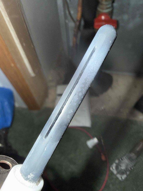 Replaced failing igniter that was showing clear signs of degradation and potential for imminent failure. Visual inspection revealed surface oxidation and wear on the metal components. System also exhibited significant condensation/frost formation on refrigerant lines, indicating possible refrigerant flow issues that were addressed during service.