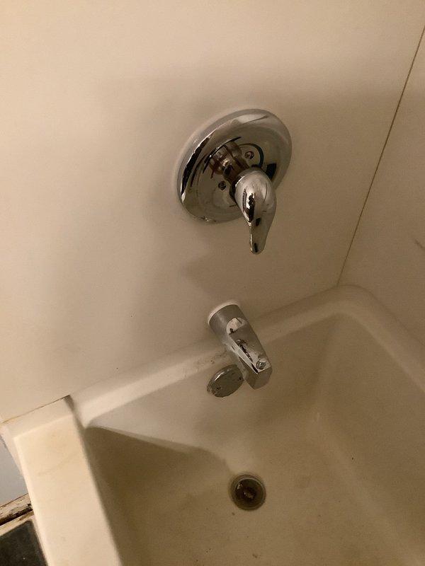Replaced corroded water supply valves in basement ceiling and rebuilt plumbing lines extending to the shower valve. Installed new Moen Chatteau chrome tub/shower faucet to resolve water control issues. Customer advised that drywall repairs would be their responsibility.