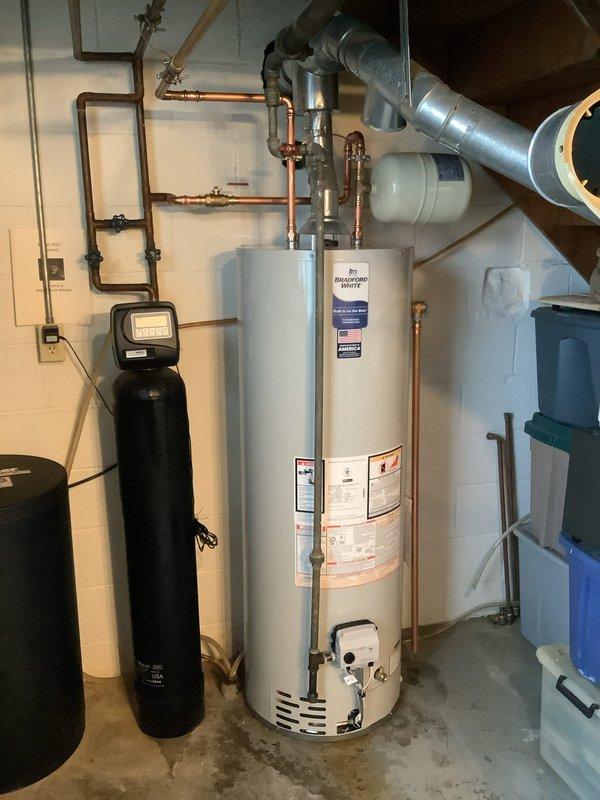 Successfully completed replacement of leaking 40-gallon tall gas water heater with new unit featuring 6-year manufacturer warranty. Work included rebuilding hot and cold water lines, replacing gas and cold water inlet valves, installing thermal expansion tank, bonding water lines, and extending the relief drop. All components were properly installed according to code requirements in the utility area.