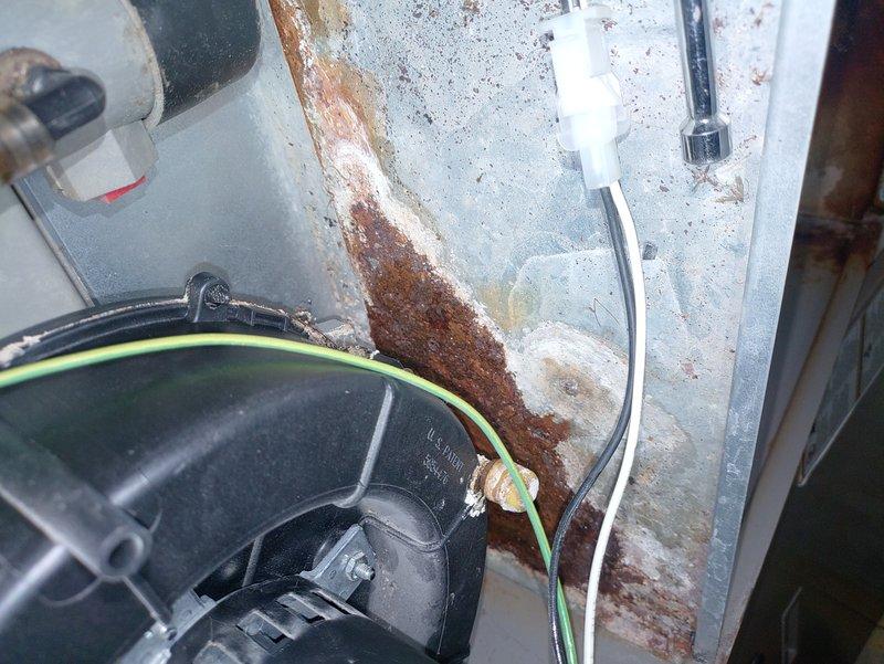 Performed diagnostic inspection on 25+ year old furnace exhibiting intermittent ignition issues. Identified significant rust damage on internal components and heat exchanger, along with corrosion affecting electrical connections. Recommended replacement due to safety concerns and deteriorated condition of critical components.