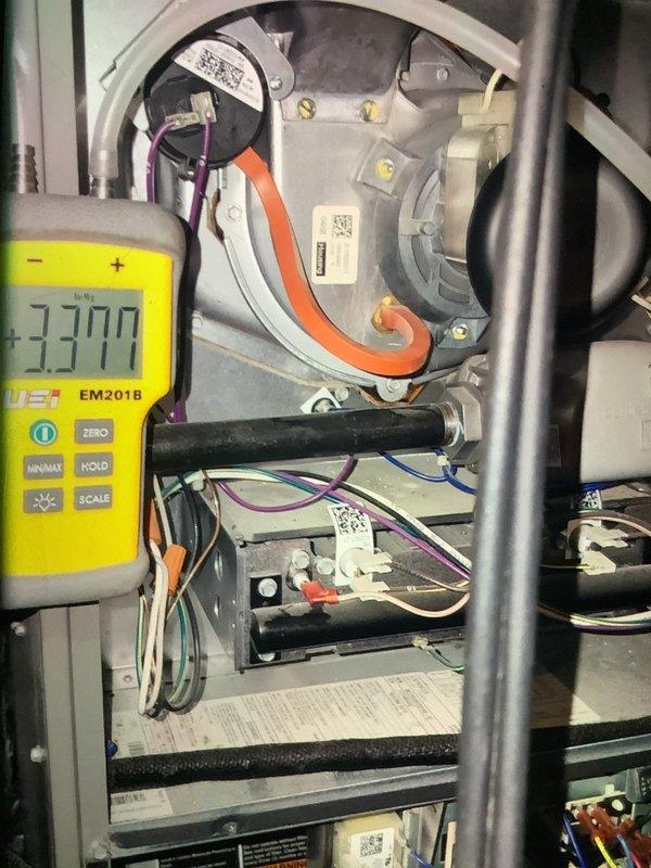 Performed comprehensive furnace tune-up including electrical system diagnostics with multimeter testing showing -3.370 reading on control board components. Inspected evaporator coil assembly which displayed normal condition with some mineral deposits in condensate pan. All refrigerant lines, electrical connections, and fan motor assembly were examined and verified to be operating within specifications.