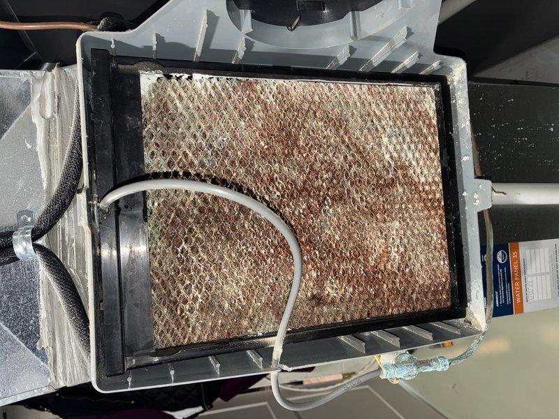 Performed routine maintenance on a 5-year-old gas furnace (BS-MVP Heating Visit). Inspected Aprilaire whole-home humidifier system mounted to ductwork with connected PVC piping. Discovered heavily soiled air filter requiring replacement due to significant dust and contaminant accumulation.