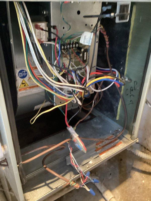 Performed scheduled maintenance visit on furnace system. Conducted thorough inspection of electrical components and wiring connections within the unit, noting complex but functional wiring arrangement. Examined the Aprilaire Home Comfort Control unit mounted on the HVAC cabinet, documenting some signs of wear on the controller.