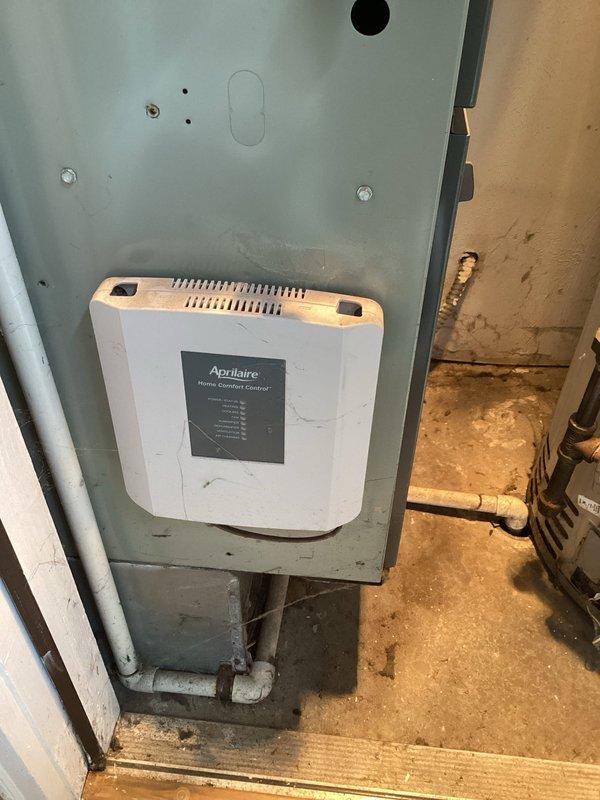 Performed scheduled maintenance visit on furnace system. Conducted thorough inspection of electrical components and wiring connections within the unit, noting complex but functional wiring arrangement. Examined the Aprilaire Home Comfort Control unit mounted on the HVAC cabinet, documenting some signs of wear on the controller.