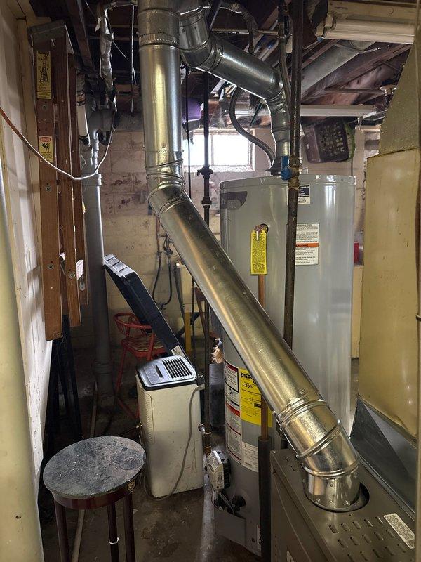 Completed installation of an 80% efficiency furnace as the second job at this location. The new unit was properly connected to existing ductwork in the utility room, with all connections secured and labeled according to manufacturer specifications. System was tested for proper operation and is functioning as designed alongside the existing water heater and humidifier installation.