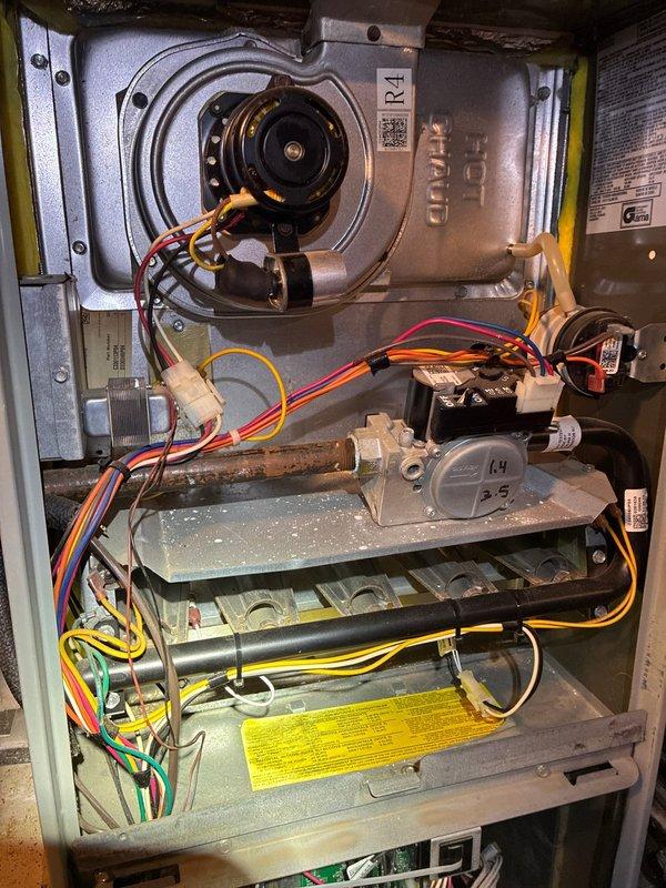 Performed annual heating tune-up on 10+ year old gas furnace. Removed access panel to inspect blower motor assembly, gas valve components and heat exchanger. Combustion analysis with Bacharach analyzer showed acceptable readings (O₂: 12.1%, CO: 22ppm, CO₂: 5.0%, Lambda: 2.36), indicating proper operation within normal parameters.