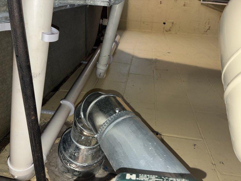 Conducted routine maintenance on the HVAC heating system, inspecting the mechanical utility area including ductwork, ventilation components, and associated plumbing network. Examined the blue valve handle and brass fittings for proper operation, confirming all connections were secure with no signs of corrosion or leakage in the piping system.