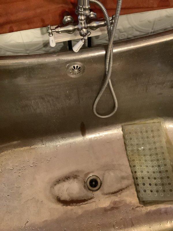 Completed replacement of dripping bathroom sink faucet along with installation of new shut-off valves. Inspected P-trap configuration and drain system to ensure proper function and absence of leaks. Also examined bathtub fixtures which appeared functional despite some minor surface discoloration around drain area.