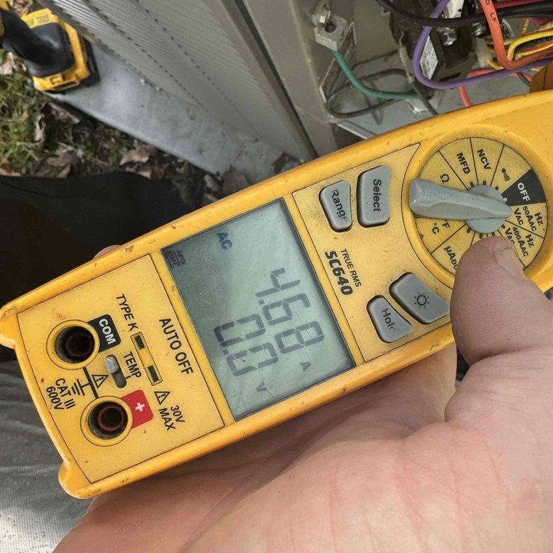Performed routine A/C maintenance after 2:30 as requested. Conducted electrical testing with Fieldpiece ST660 multimeter, obtaining voltage reading of 168.0V. Inspected capacitor connections (purple, red, yellow wires) and mounting hardware; all components appeared in normal working condition with expected wear.