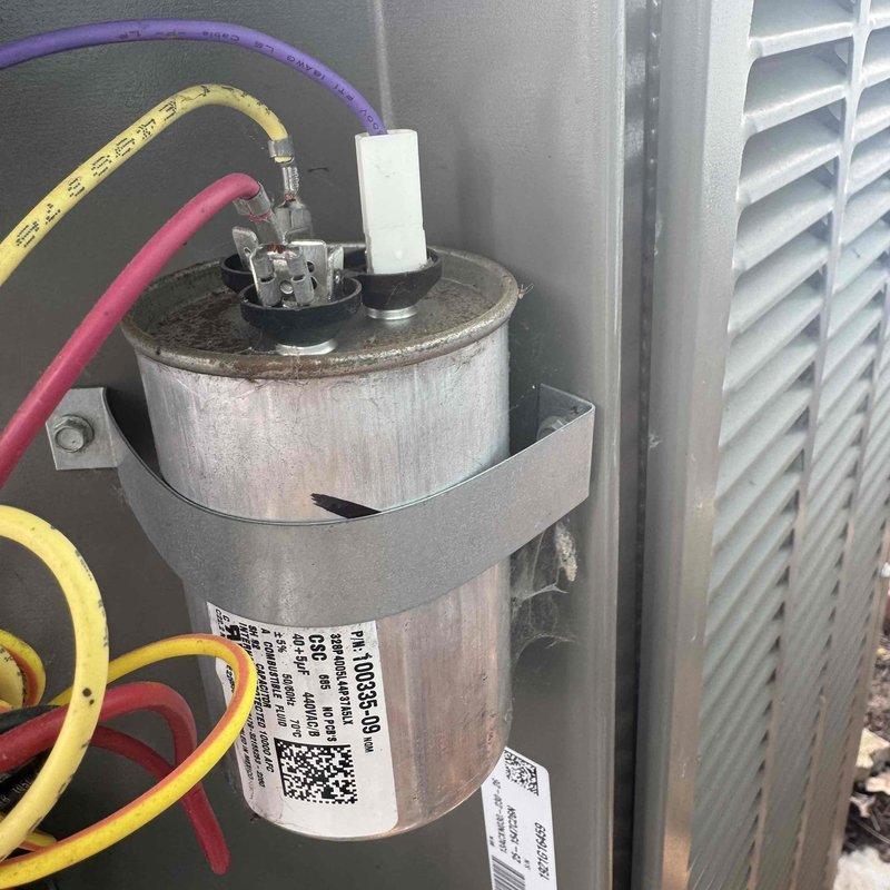 Performed routine A/C maintenance after 2:30 as requested. Conducted electrical testing with Fieldpiece ST660 multimeter, obtaining voltage reading of 168.0V. Inspected capacitor connections (purple, red, yellow wires) and mounting hardware; all components appeared in normal working condition with expected wear.