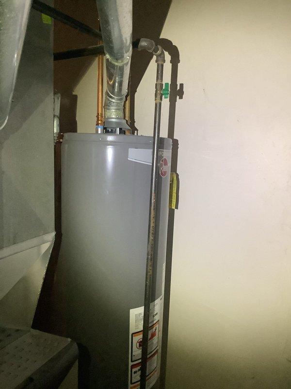 Diagnosed and repaired corrosion at the top of the tanked water heater where it connects to the water supply line. Inspected adjacent HVAC system to ensure no related issues were present, and verified proper functionality of all connections after repair was completed.