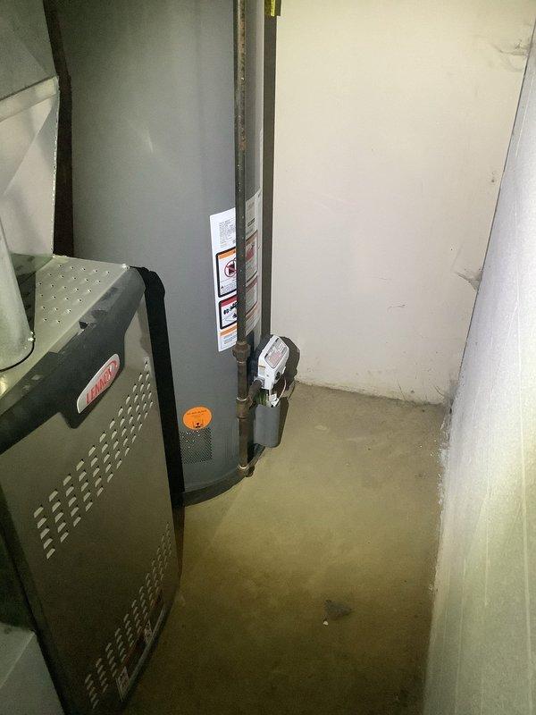 Diagnosed and repaired corrosion at the top of the tanked water heater where it connects to the water supply line. Inspected adjacent HVAC system to ensure no related issues were present, and verified proper functionality of all connections after repair was completed.