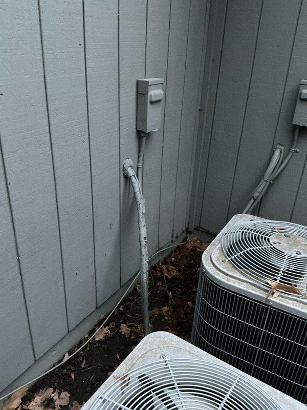 Conducted site assessment for furnace replacement at residential property with 32-year-old existing system. Exterior inspection revealed two aging condenser units with weathered components and electrical connections requiring evaluation. Interior examination of attic space showed metal ductwork with visible seams and insulated flexible ducting that will need to be considered in the replacement plan.