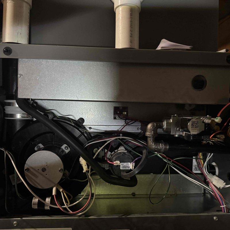 Performed scheduled BS-MVP Heating Visit on 2-year-old unit. Inspected PCB components including DIP switch banks (HLCD ADF.08S) and verified proper switch positioning. Examined blower motor assembly, checked wiring connections, and confirmed proper operation of the ventilation system with no visible issues detected.