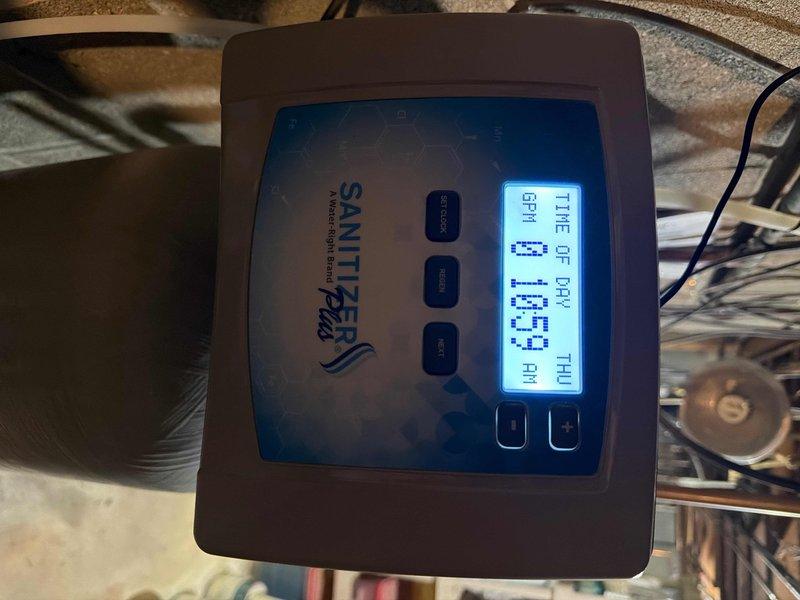 Completed replacement of 25-year-old twin tank water softener with new Sanitizer softener system. Installed digital control panel and connected all necessary plumbing lines to existing infrastructure. Staged six bags of salt for system operation and verified proper functioning of new unit with successful programming of control settings.