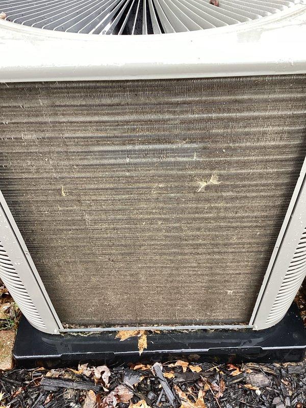 Performed routine cooling maintenance and identified severely clogged condenser coils with heavy dust, debris, and organic matter accumulation at base of unit. Cleaned condenser coils to restore proper airflow and system efficiency, which should improve cooling performance and prevent potential system strain.