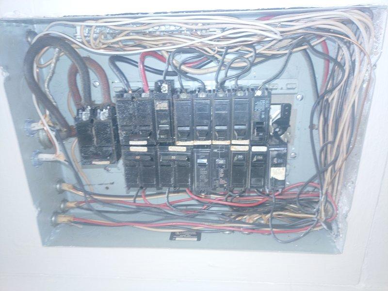 Inspected electrical panel to evaluate feasibility of connecting electric stove to existing 220V dryer circuit. Documented deteriorated insulation on supply lines and assessed current breaker configuration. Determined separate dedicated circuit would be required for code compliance and safe operation of both appliances.