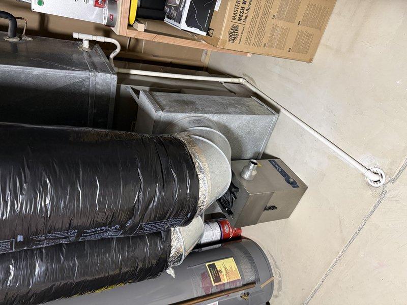 Completed comprehensive assessment for heating and cooling system replacement in medium-sized residential property (1500-3000 sq.ft.) with basement installation. Evaluated existing ductwork condition, noting proper metal elbow joints and connections, and inspected current furnace/air handler unit with associated black insulated ducts. Recommended Lennox A/C and gas furnace vertical upflow/downflow system as optimal replacement solution for the property's requirements.