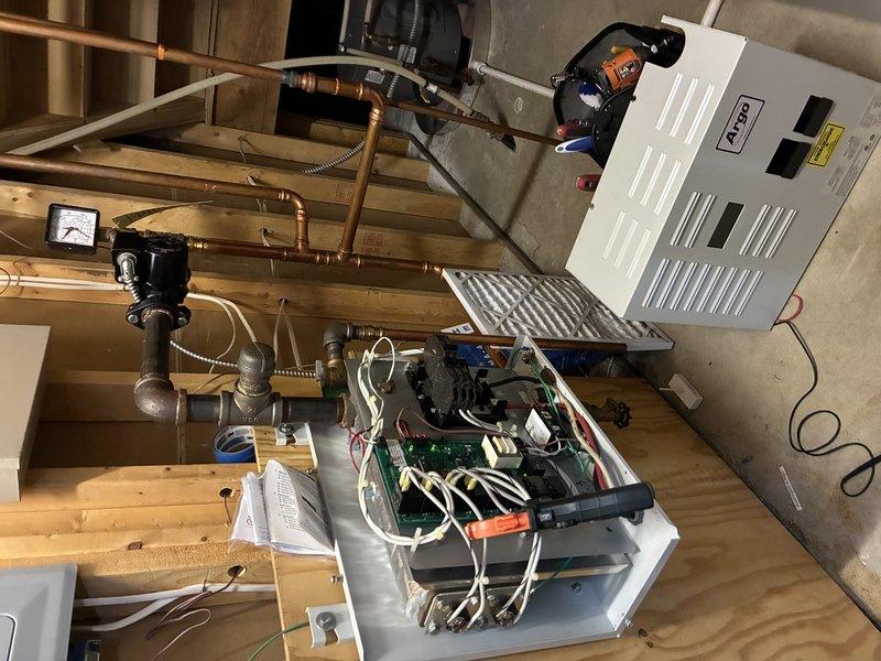 Successfully completed replacement of faulty circuit board and both heating elements in customer's AHS HVAC system. Accessed and serviced electrical control panel components in basement utility area, ensuring proper connection to existing plumbing infrastructure which includes a Standard pressure regulating valve and RP-40 equilibrium valve assembly.