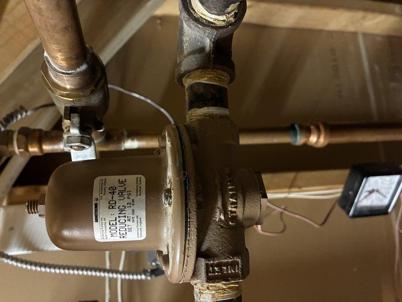 Successfully completed replacement of faulty circuit board and both heating elements in customer's AHS HVAC system. Accessed and serviced electrical control panel components in basement utility area, ensuring proper connection to existing plumbing infrastructure which includes a Standard pressure regulating valve and RP-40 equilibrium valve assembly.