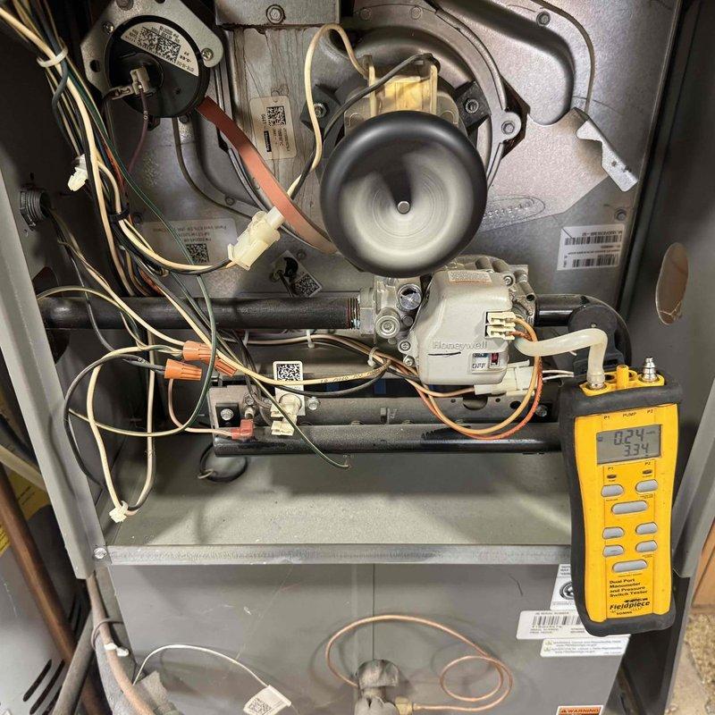Performed routine maintenance on 6-year-old gas furnace. Inspected interior components including blower motor, electrical connections, and Honeywell control module. Conducted electrical testing with multimeter to verify proper operation parameters. Recommended evaluation of ductwork for potential cleaning service.