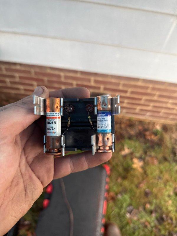 Completed installation of new 90K BTU air conditioning system with inspection and verification of electrical components. Replaced and properly secured dual cylindrical fuses (TR25R 250V/600V AC) in the disconnect box to ensure proper circuit protection for the newly installed unit.
