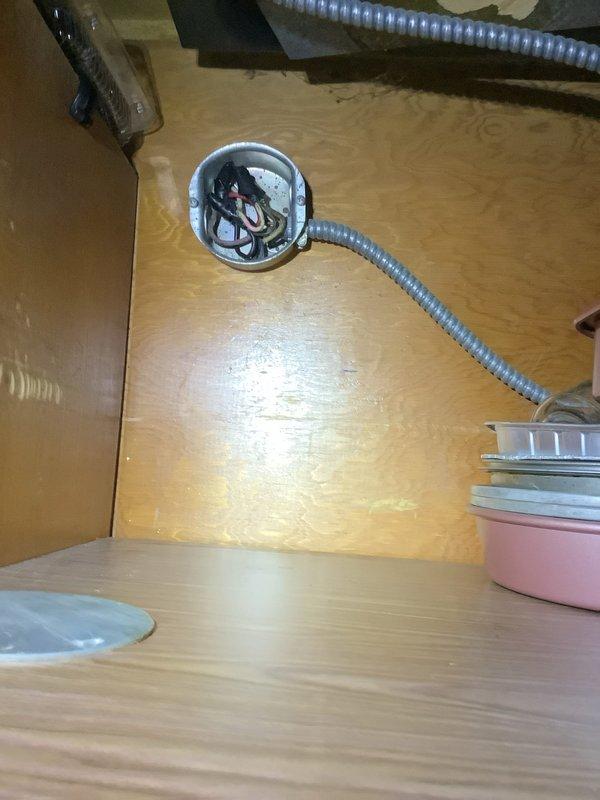 Completed installation of a switch in a new 2-gang box adjacent to existing outlet, configuring both duplexes to be switch-controlled. Replaced two bathroom fluorescent light fixtures and installed a dedicated circuit for stove top. Work included junction box installation with proper wiring connections and installation of a 15A GFCI Siemens breaker.