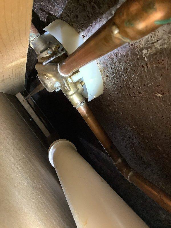 Assessed leak issue at a tub drain with suspected caulking failure after customer opened ceiling access panel. Inspected the copper supply lines and brass valve assembly, which showed normal oxidation, as well as the PVC drain components. Identified and repaired the source of water intrusion at the drain-tub connection.